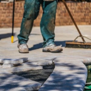 Builder sweeping up paving