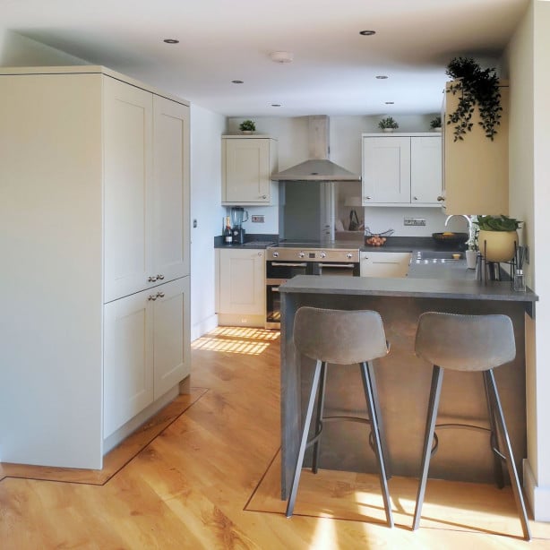 Symphony Kitchen with painted shaker cabinets and mini breakfast bar