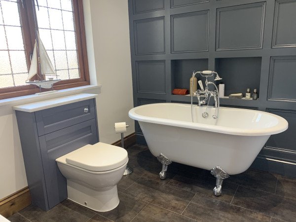 A statement freestanding bath in a Shaker bathroom