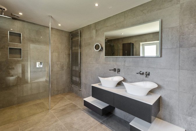 Statement basins sit atop bold wall-hung units in Anthracite Grey